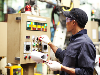 Technician working on a control panel