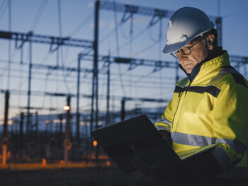 Project Manager reviewing a computer screen at an outside job-site