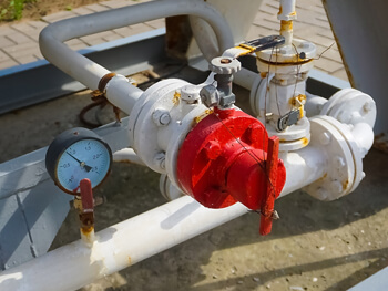 Close up view of piping and valve hook-ups of a production well